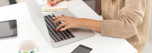 Woman managing social media accounts with a variety of technology